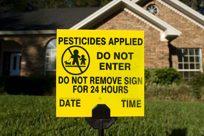 Pesticide application sign on lawn